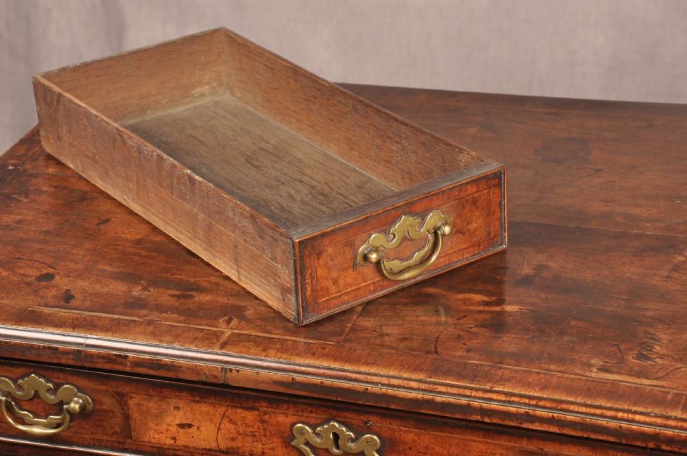 An 18th-century George II walnut lowboy side table featuring three drawers with brass handles, a shaped kneehole apron, and cabriole legs on pad feet. View V