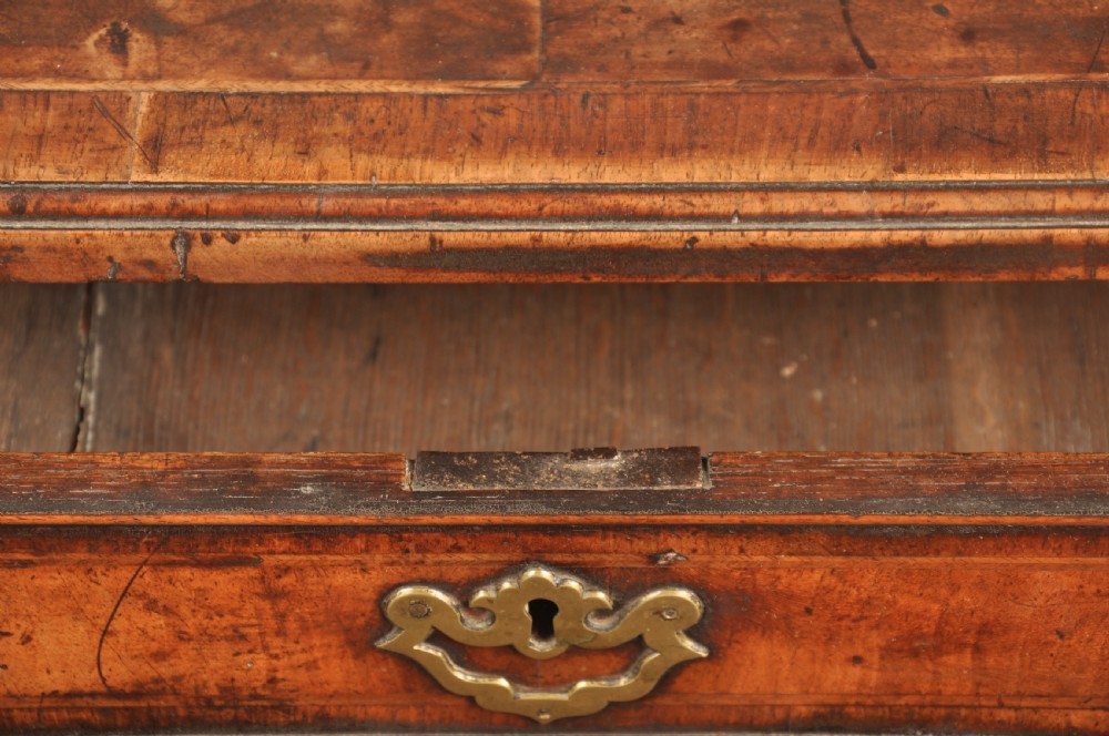 An 18th-century George II walnut lowboy side table featuring three drawers with brass handles, a shaped kneehole apron, and cabriole legs on pad feet. View VIII