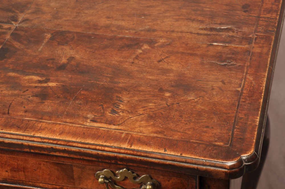 An 18th-century George II walnut lowboy side table featuring three drawers with brass handles, a shaped kneehole apron, and cabriole legs on pad feet. View X