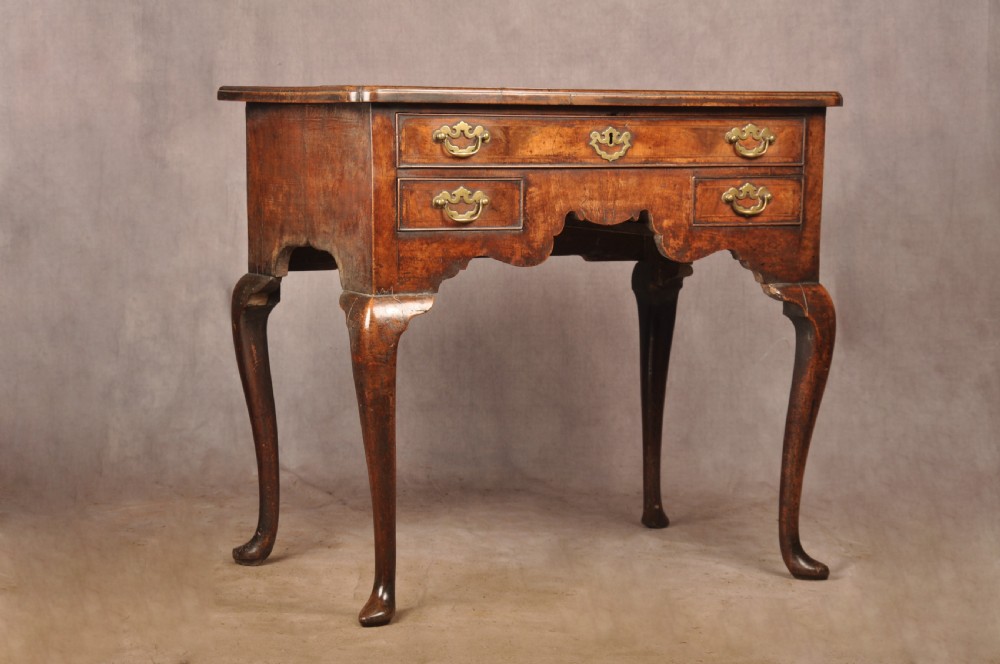 An 18th-century George II walnut lowboy side table featuring three drawers with brass handles, a shaped kneehole apron, and cabriole legs on pad feet. View XI