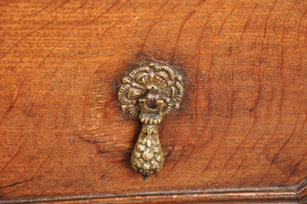 A 17th-century Charles II solid oak chest of drawers featuring geometric applied mouldings and brass teardrop handles. View III