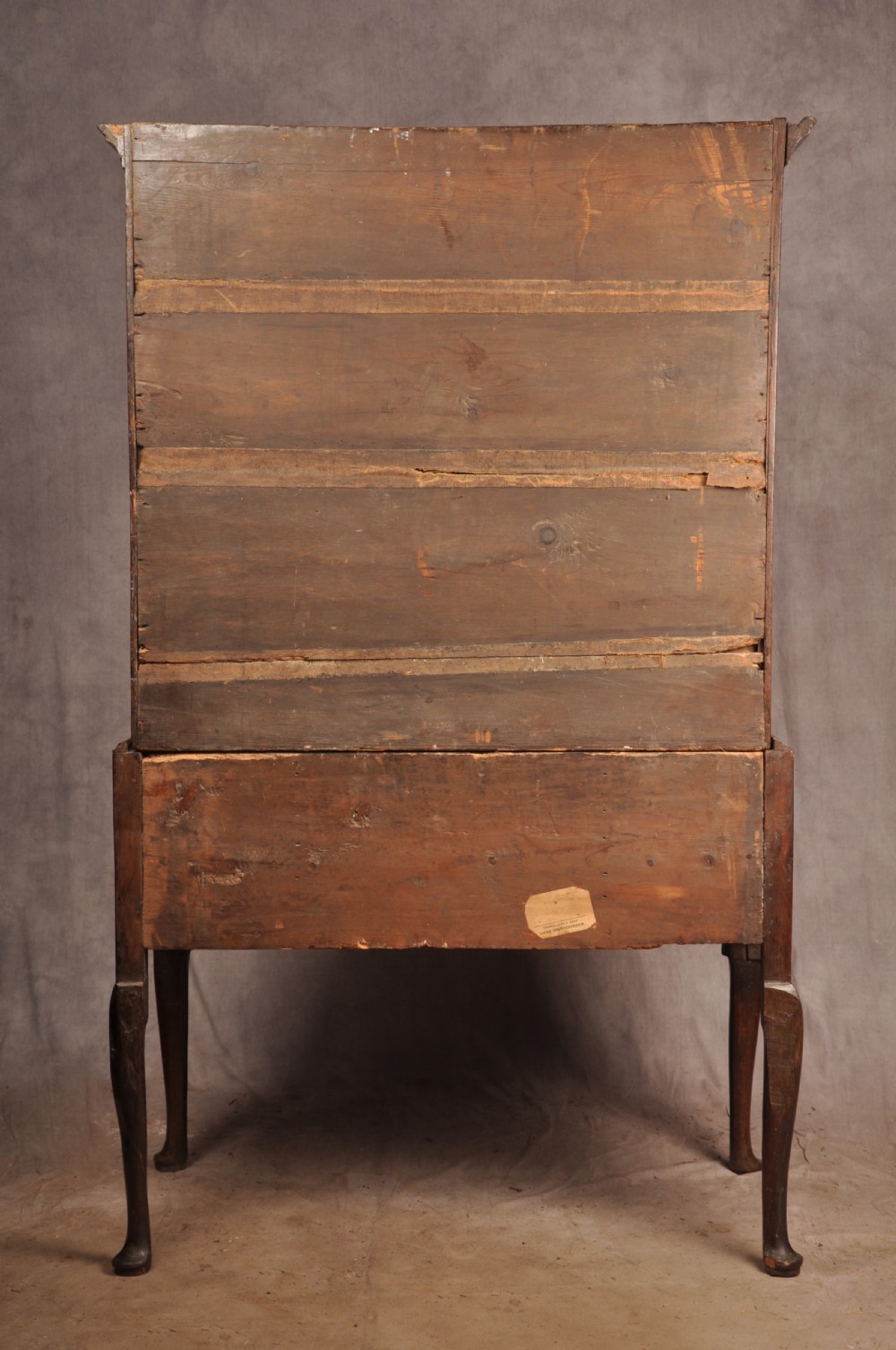 An 18th-century George I oak chest on stand featuring multiple graduated drawers with brass handles, resting on shaped cabriole legs. View IX