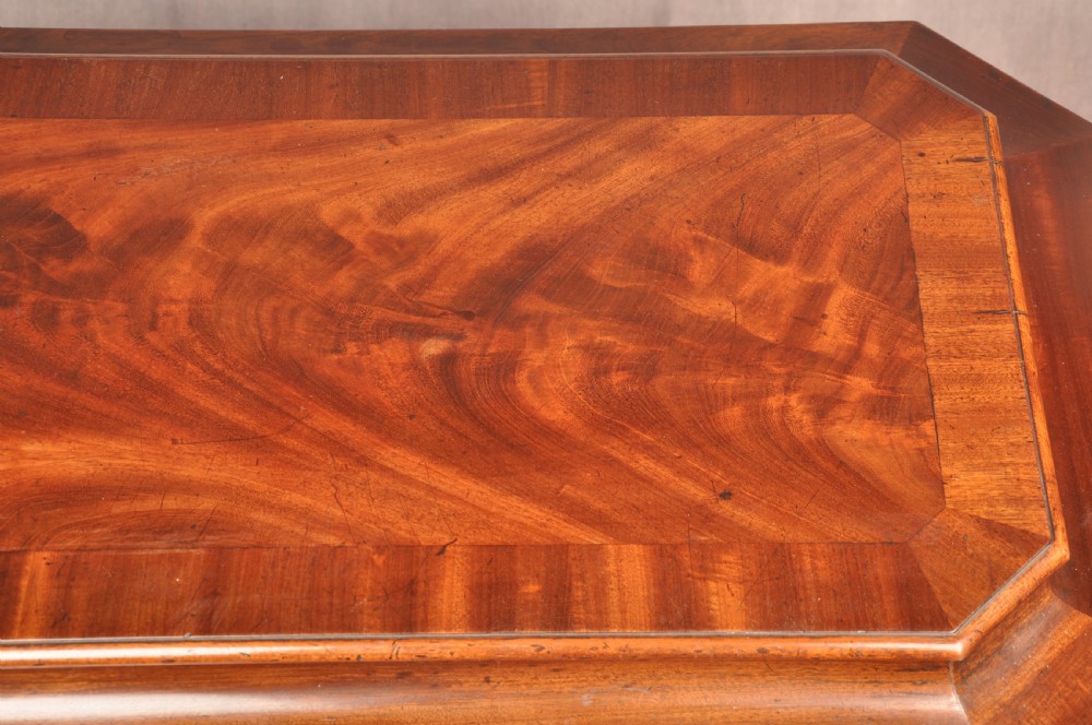 A Regency flame mahogany sarcophagus-shaped wine cooler featuring a hinged stepped lid, reeded corners, and carved paw feet. View V