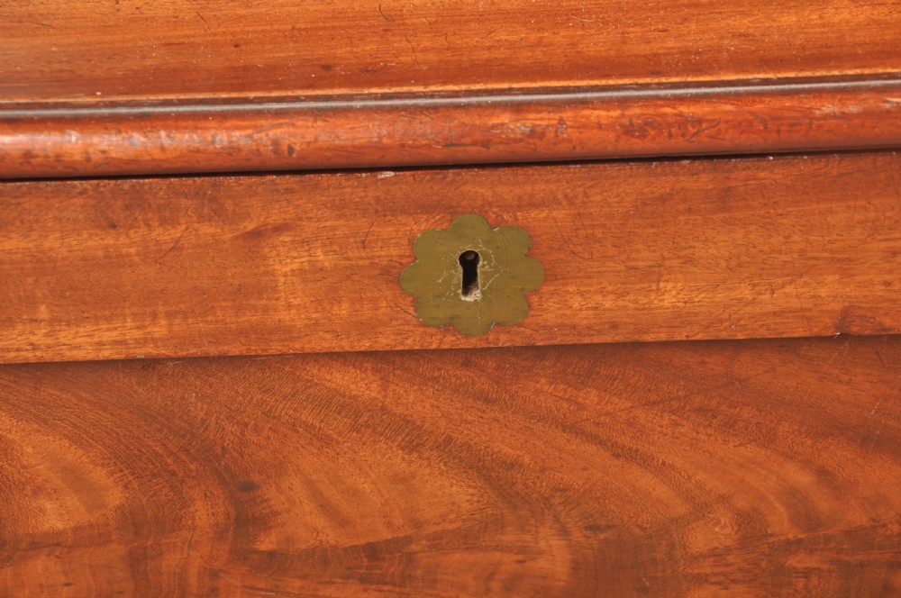 A Regency flame mahogany sarcophagus-shaped wine cooler featuring a hinged stepped lid, reeded corners, and carved paw feet. View VI