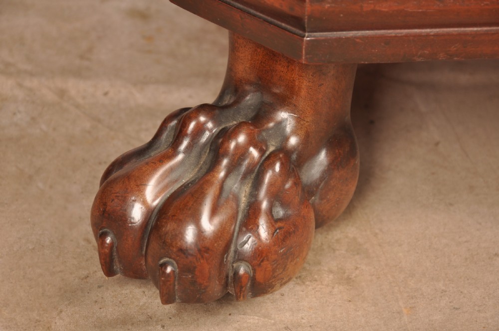 A Regency flame mahogany sarcophagus-shaped wine cooler featuring a hinged stepped lid, reeded corners, and carved paw feet. View VII