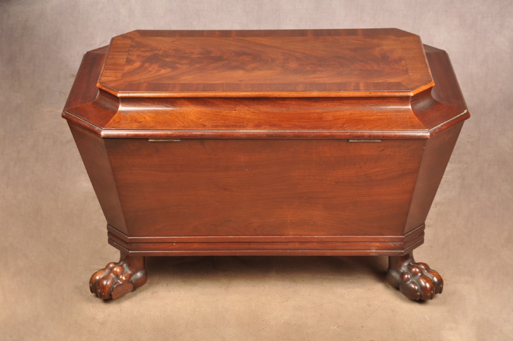A Regency flame mahogany sarcophagus-shaped wine cooler featuring a hinged stepped lid, reeded corners, and carved paw feet. View XVIII