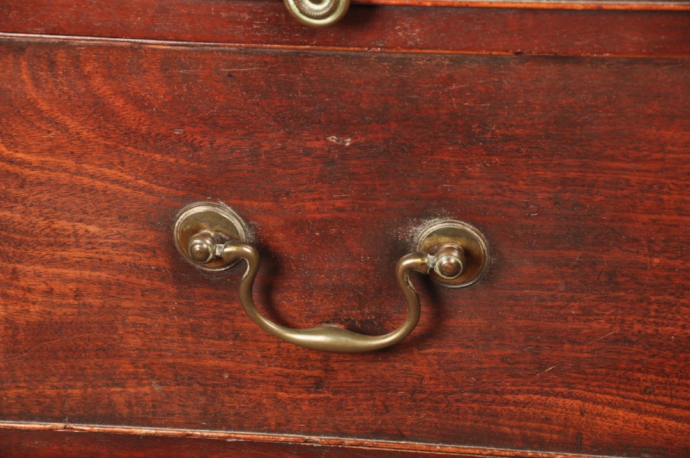 An 18th-century mahogany tallboy featuring stacked upper and lower drawer sections, brass swan-neck handles, fluted sides, and bracket feet. View III