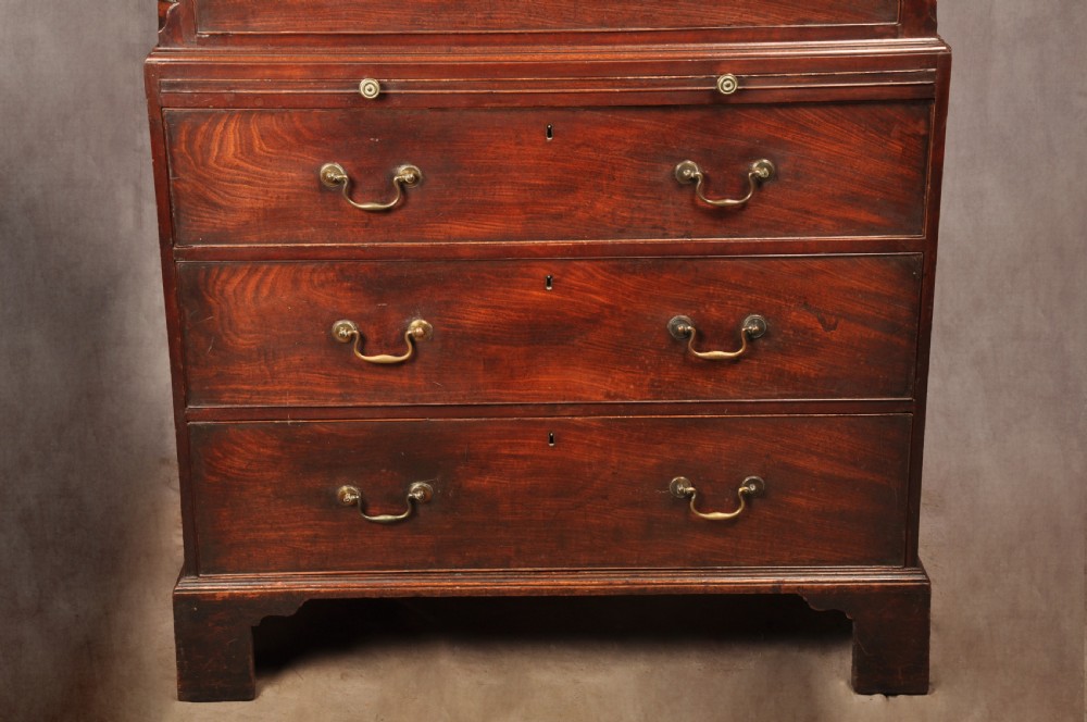 An 18th-century mahogany tallboy featuring stacked upper and lower drawer sections, brass swan-neck handles, fluted sides, and bracket feet. View V