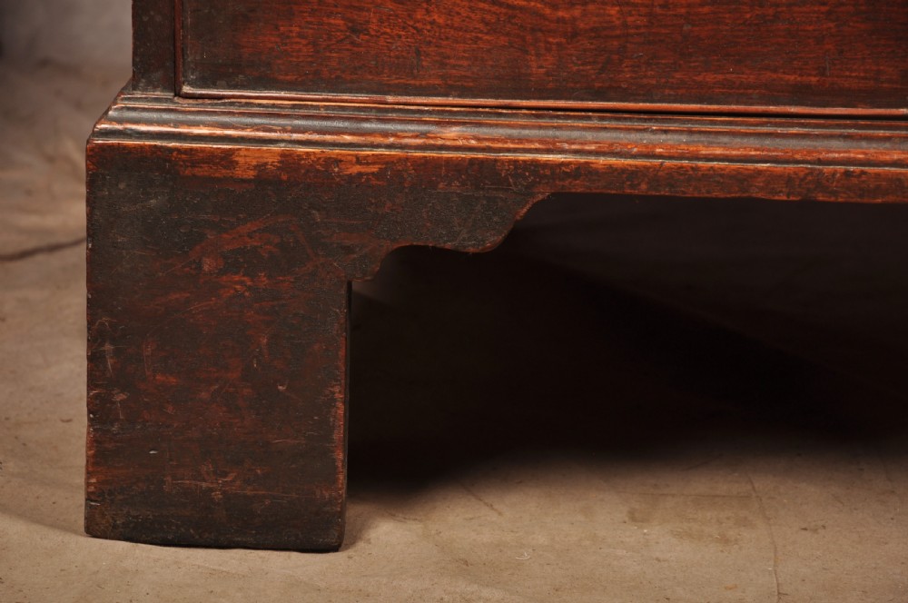 An 18th-century mahogany tallboy featuring stacked upper and lower drawer sections, brass swan-neck handles, fluted sides, and bracket feet. View VI