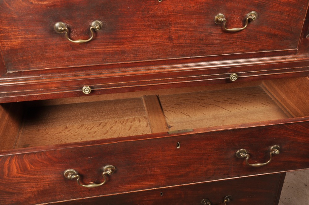An 18th-century mahogany tallboy featuring stacked upper and lower drawer sections, brass swan-neck handles, fluted sides, and bracket feet. View VIII