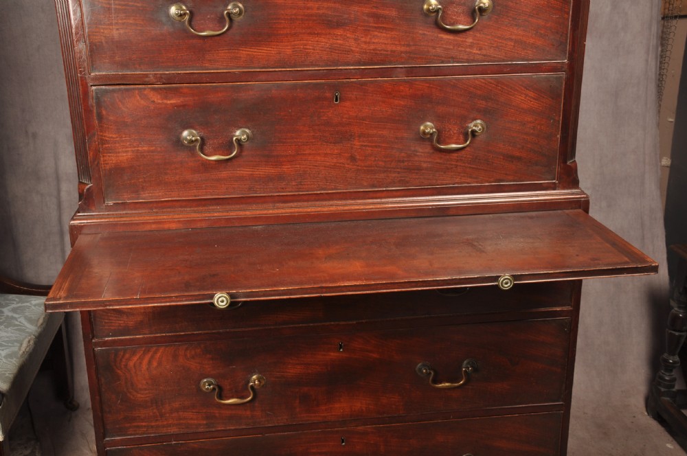 An 18th-century mahogany tallboy featuring stacked upper and lower drawer sections, brass swan-neck handles, fluted sides, and bracket feet. View IX