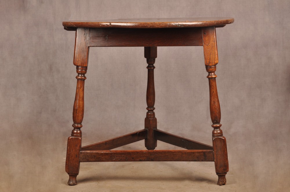 An 18th-century circular timber cricket table with three turned legs connected by a low triangular stretcher. View VIII