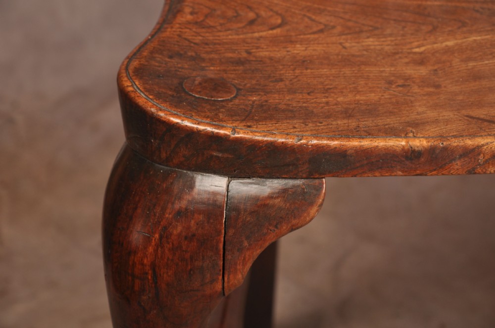 An 18th-century cherrywood Thames Valley Windsor armchair featuring a high comb back, pierced fretwork splat, curved armrests, saddled seat, and cabriole front legs. View VII