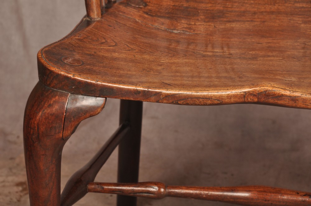 An 18th-century cherrywood Thames Valley Windsor armchair featuring a high comb back, pierced fretwork splat, curved armrests, saddled seat, and cabriole front legs. View VIII