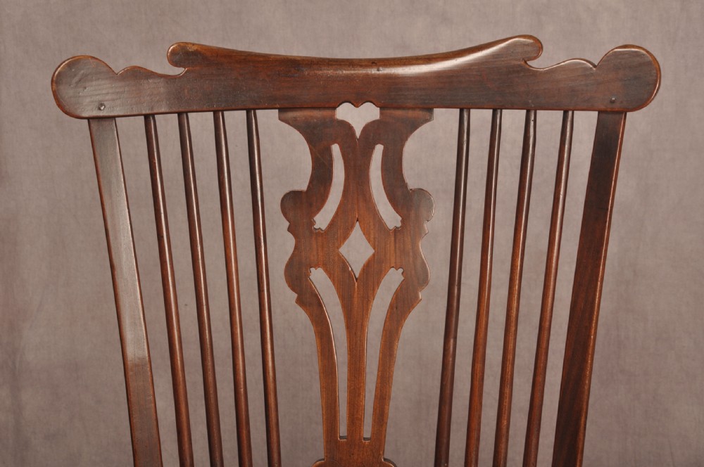An 18th-century cherrywood Thames Valley Windsor armchair featuring a high comb back, pierced fretwork splat, curved armrests, saddled seat, and cabriole front legs. View IX