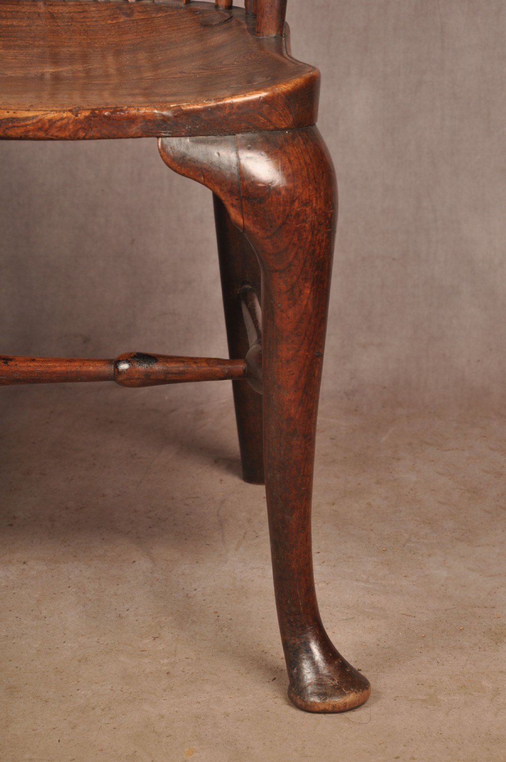 An 18th-century cherrywood Thames Valley Windsor armchair featuring a high comb back, pierced fretwork splat, curved armrests, saddled seat, and cabriole front legs. View X