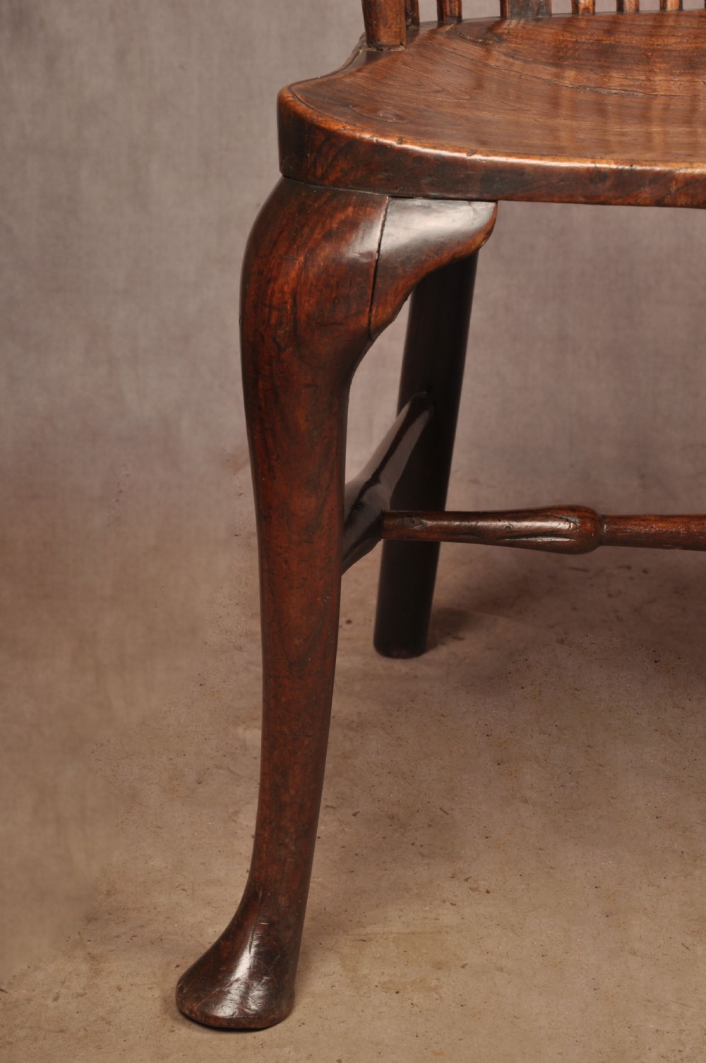 An 18th-century cherrywood Thames Valley Windsor armchair featuring a high comb back, pierced fretwork splat, curved armrests, saddled seat, and cabriole front legs. View XI