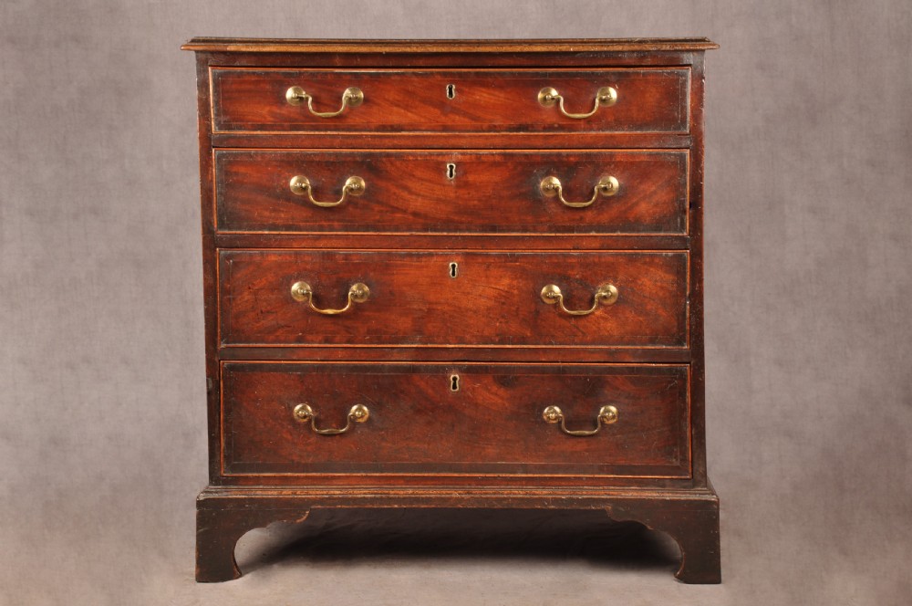 An eighteenth-century Georgian mahogany chest of drawers featuring four graduated drawers with brass swan-neck handles and bracket feet.