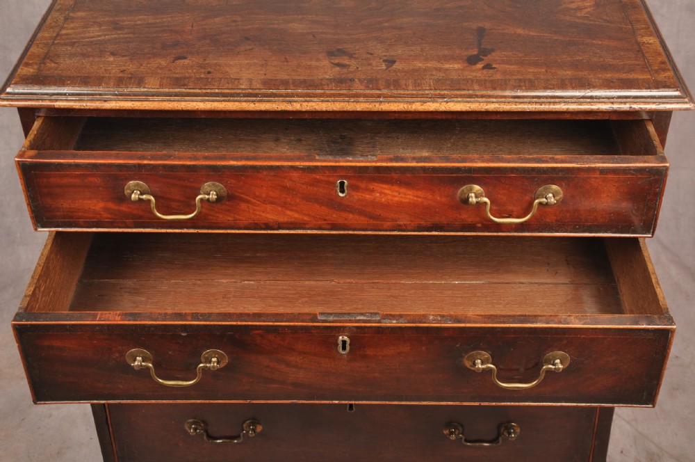 An eighteenth-century Georgian mahogany chest of drawers featuring four graduated drawers with brass swan-neck handles and bracket feet. View III