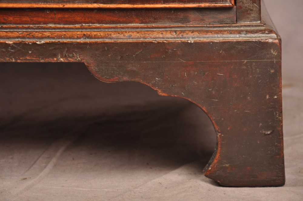 An eighteenth-century Georgian mahogany chest of drawers featuring four graduated drawers with brass swan-neck handles and bracket feet. View VI