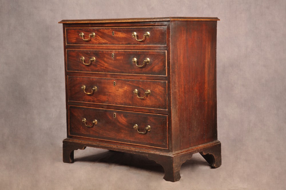 An eighteenth-century Georgian mahogany chest of drawers featuring four graduated drawers with brass swan-neck handles and bracket feet. View VIII
