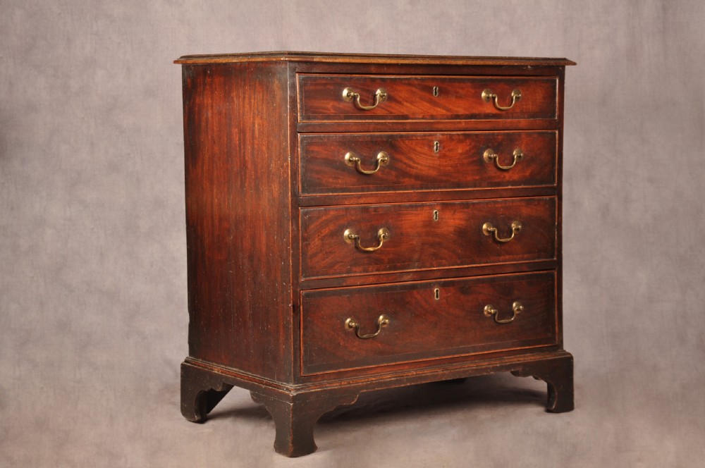An eighteenth-century Georgian mahogany chest of drawers featuring four graduated drawers with brass swan-neck handles and bracket feet. View IX