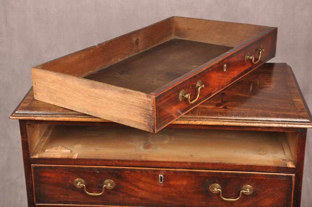 An eighteenth-century Georgian mahogany chest of drawers featuring four graduated drawers with brass swan-neck handles and bracket feet. View XII