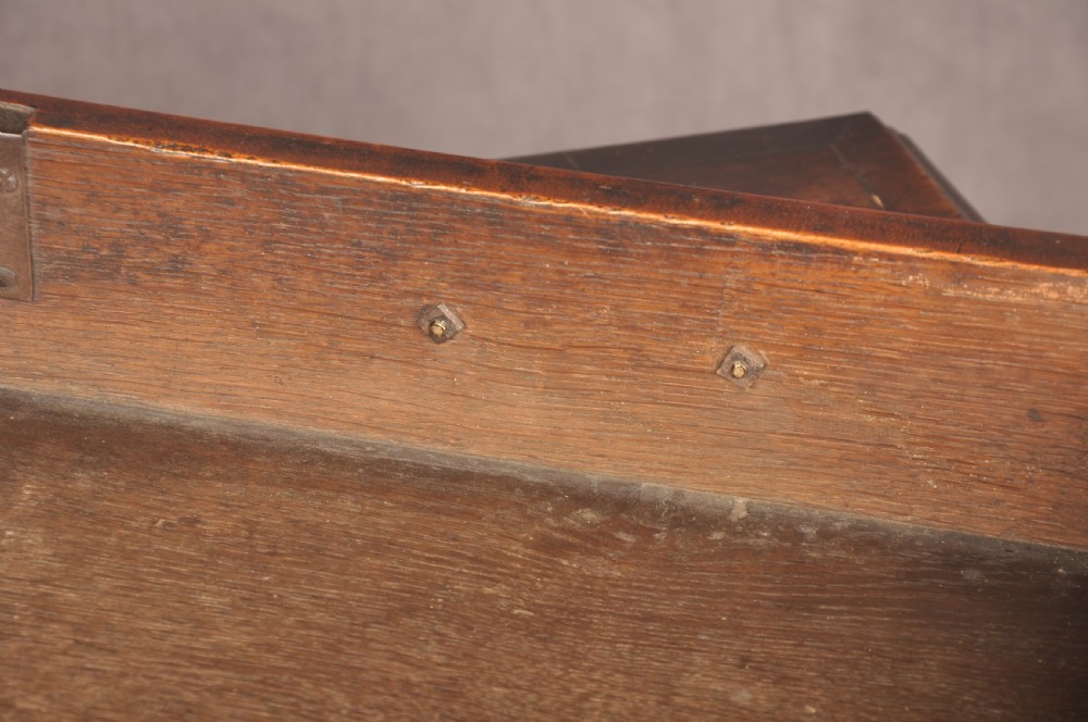 An eighteenth-century Georgian mahogany chest of drawers featuring four graduated drawers with brass swan-neck handles and bracket feet. View XIV