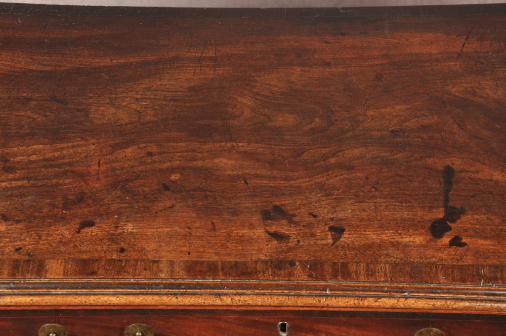 An eighteenth-century Georgian mahogany chest of drawers featuring four graduated drawers with brass swan-neck handles and bracket feet. View XV