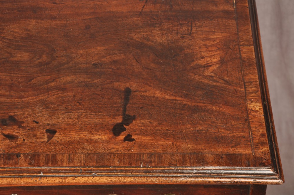 An eighteenth-century Georgian mahogany chest of drawers featuring four graduated drawers with brass swan-neck handles and bracket feet. View XVI