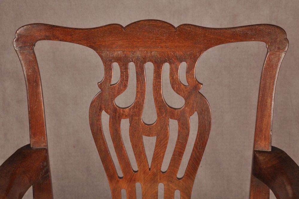A George II mahogany armchair featuring a pierced back splat, swept armrests, a cream fabric seat, and cabriole front legs. View IV