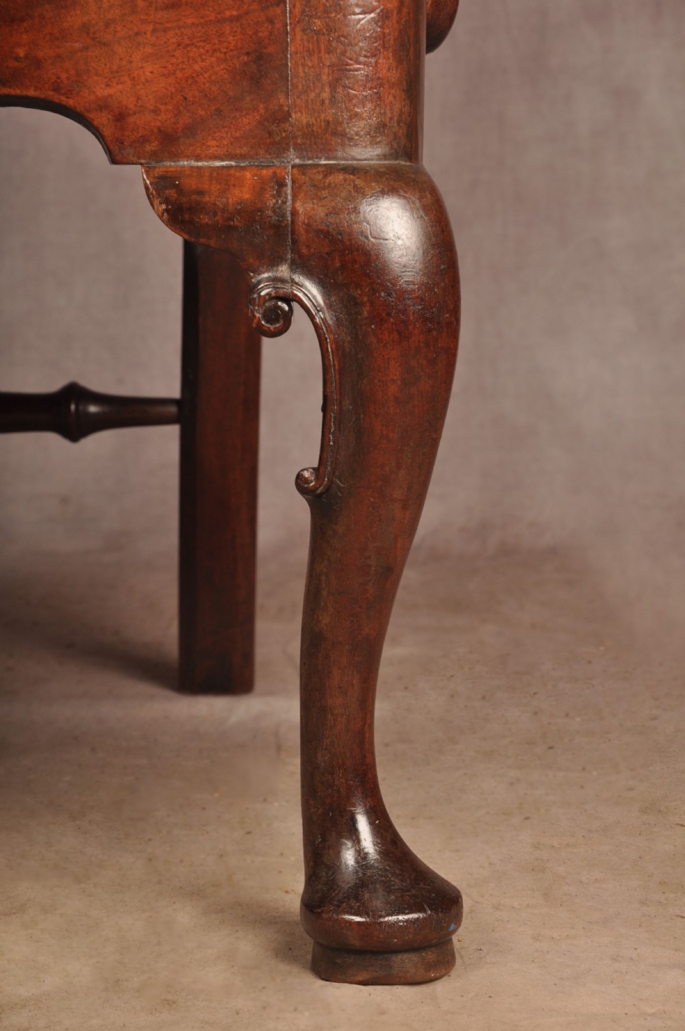 A George II mahogany armchair featuring a pierced back splat, swept armrests, a cream fabric seat, and cabriole front legs. View V
