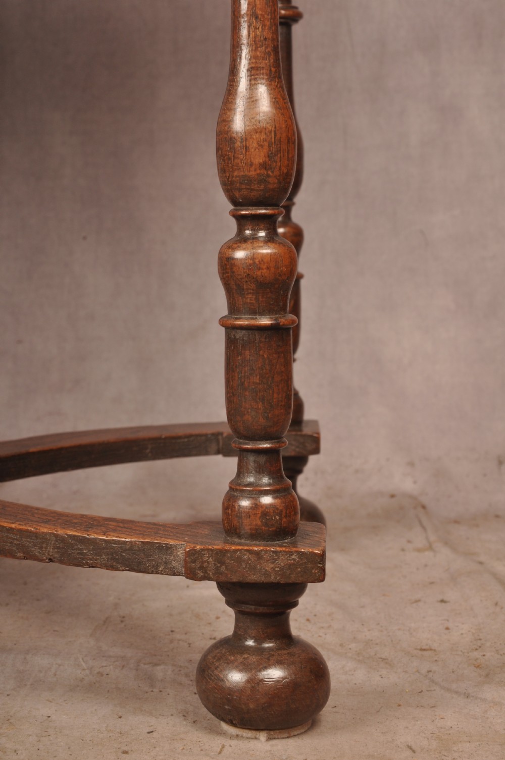 A 17th-century oak side table featuring baluster-turned legs, a shaped X-stretcher, a single frieze drawer with a brass drop handle, and a rectangular timber top. View VI
