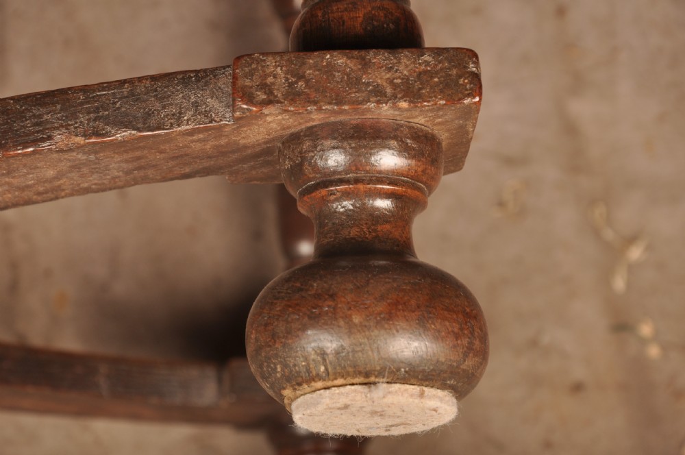 A 17th-century oak side table featuring baluster-turned legs, a shaped X-stretcher, a single frieze drawer with a brass drop handle, and a rectangular timber top. View XIV