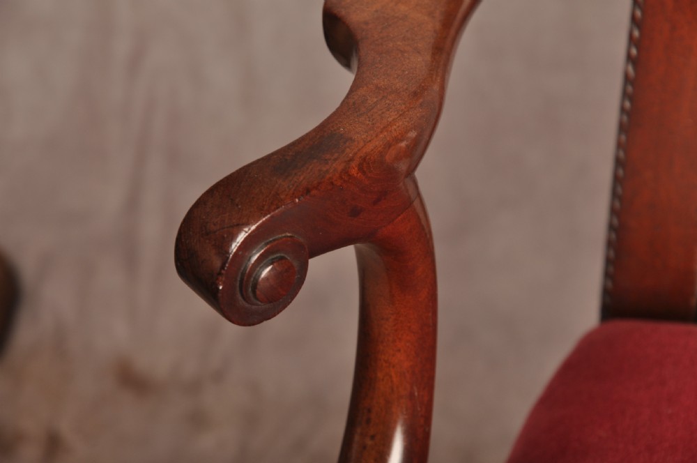 An 18th-century Chippendale style mahogany armchair featuring a pierced lattice splat back, curved arms, square legs with stretchers, and a red upholstered seat. View VII