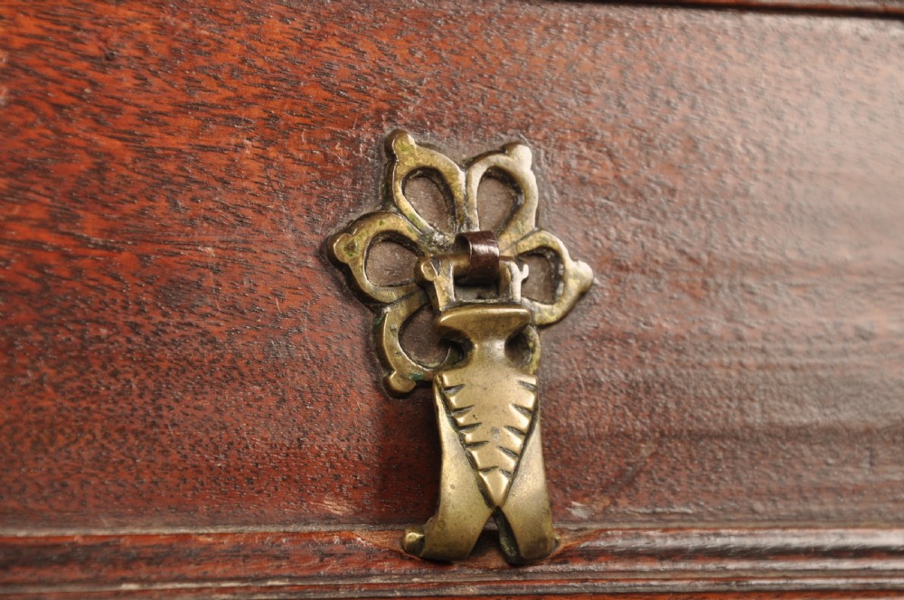 A 17th-century Charles II walnut and fruitwood chest of drawers featuring geometric mitred panels and brass keyhole escutcheons. View VII