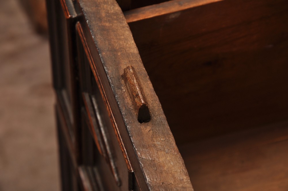 A 17th-century Charles II walnut and fruitwood chest of drawers featuring geometric mitred panels and brass keyhole escutcheons. View XVIII