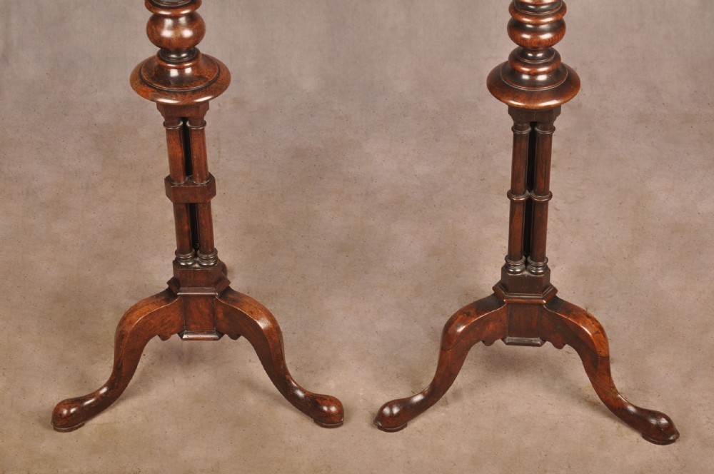 A pair of dark rosewood pedestal stands featuring turned baluster shafts, shaped tops, and tripod bases with pad feet. View V