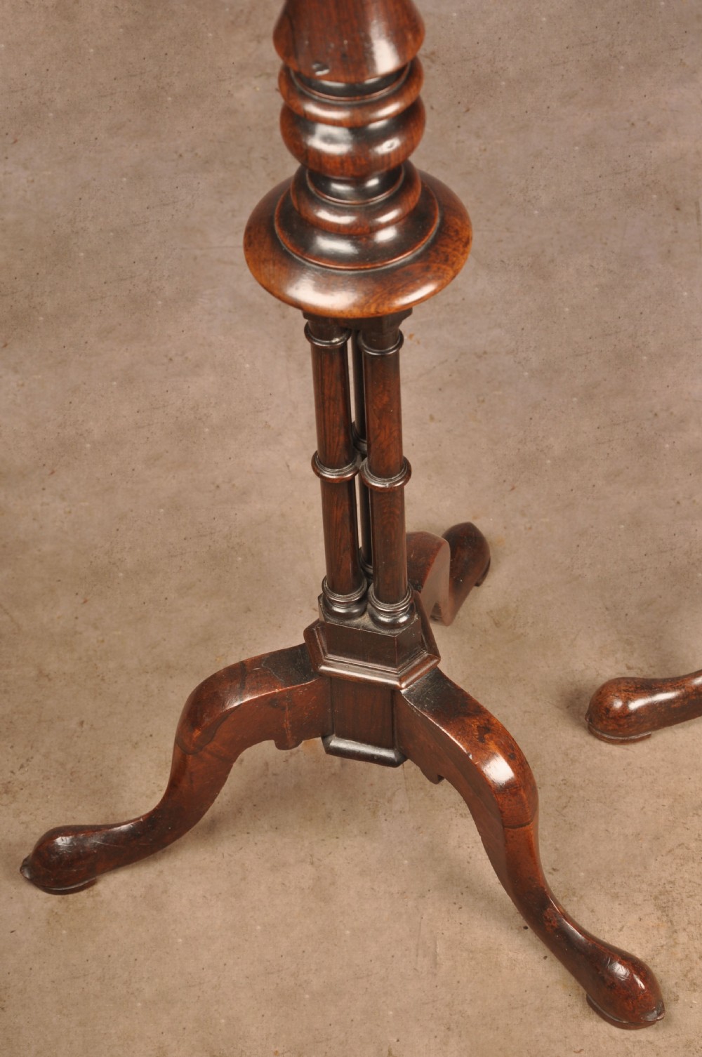 A pair of dark rosewood pedestal stands featuring turned baluster shafts, shaped tops, and tripod bases with pad feet. View VII