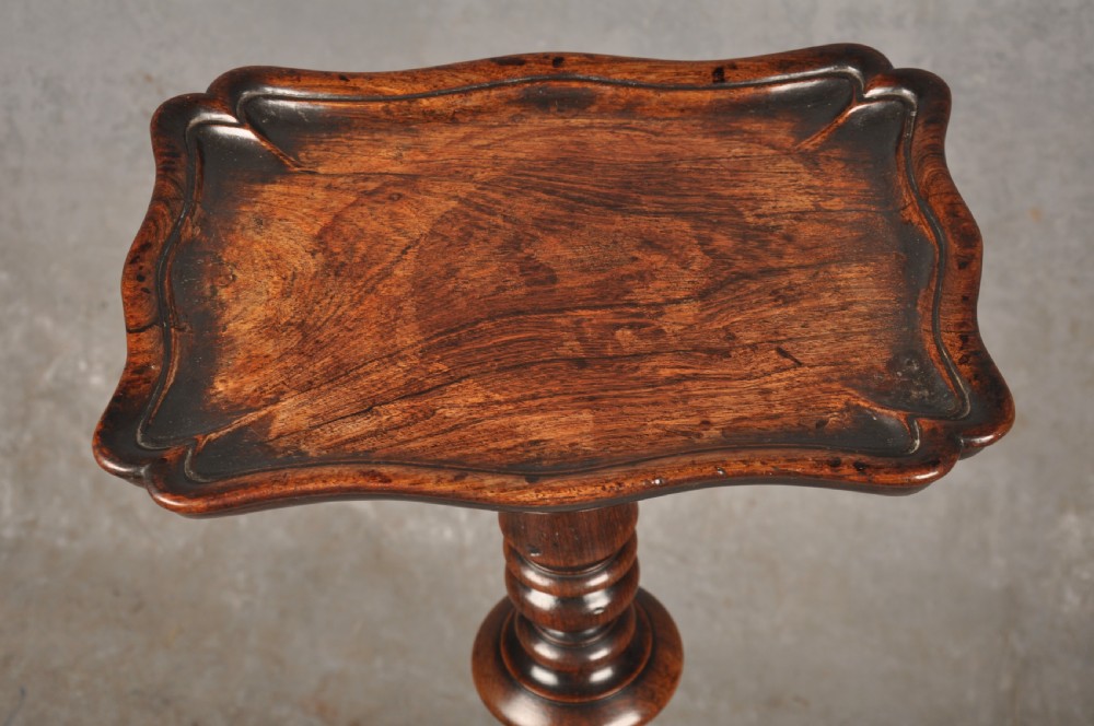 A pair of dark rosewood pedestal stands featuring turned baluster shafts, shaped tops, and tripod bases with pad feet. View X