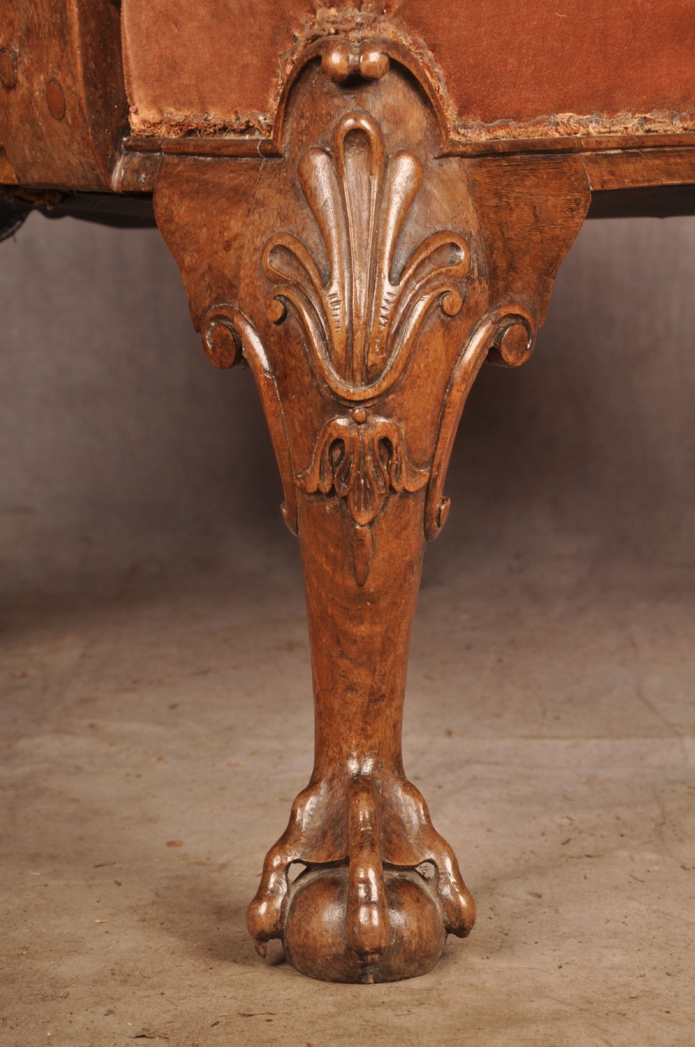 A 19th-century walnut library armchair upholstered in terracotta velvet with carved cabriole legs and claw and ball feet. View III