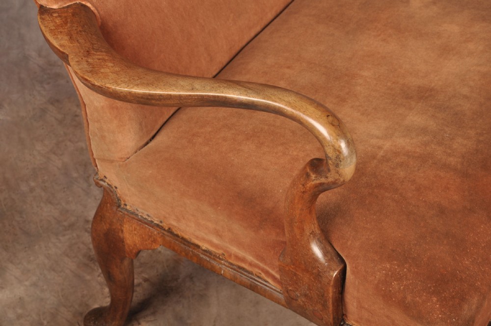 A 19th-century walnut library armchair upholstered in terracotta velvet with carved cabriole legs and claw and ball feet. View VI