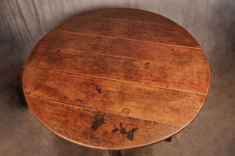 An 18th-century oak gateleg dining table with folded drop leaves, turned legs, and square stretchers. View III