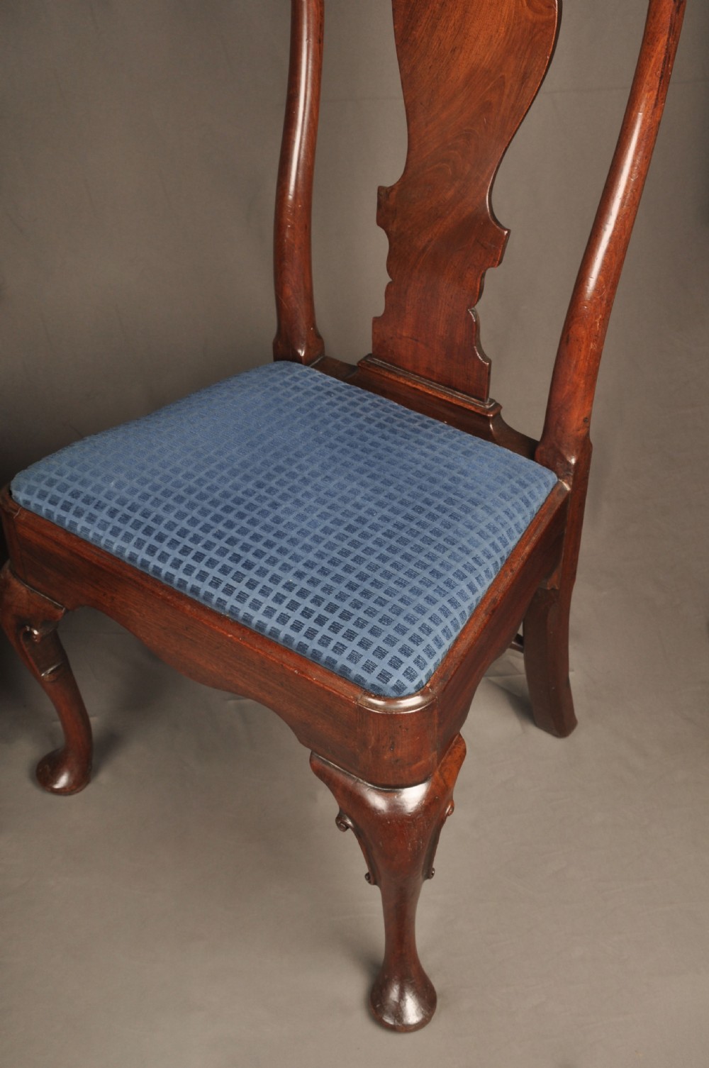 A pair of George I mahogany side chairs featuring vase-shaped back splats, blue patterned drop-in seats, and cabriole front legs. View VII
