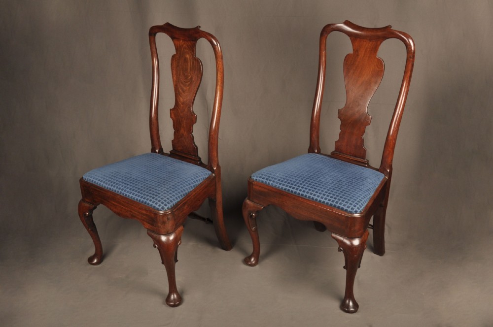 A pair of George I mahogany side chairs featuring vase-shaped back splats, blue patterned drop-in seats, and cabriole front legs. View X