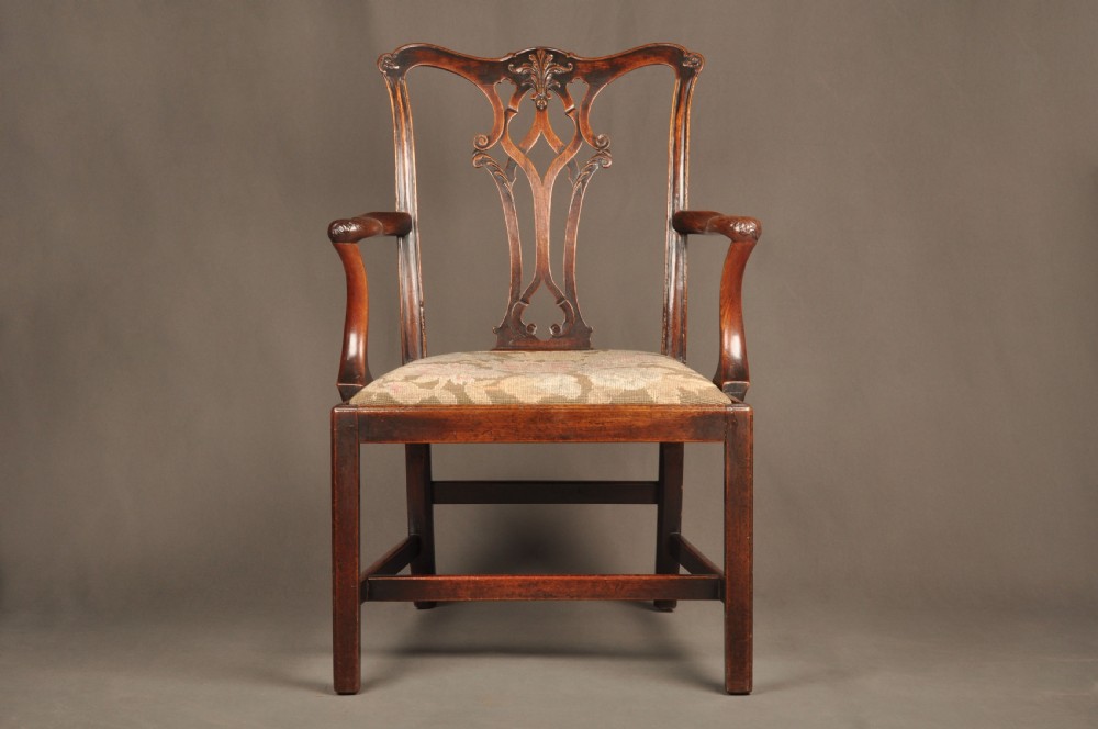 An 18th-century Chippendale mahogany armchair featuring a carved pierced splat back, swept armrests, an upholstered drop-in seat, and square legs joined by H-stretchers. View II