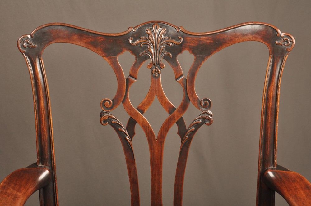 An 18th-century Chippendale mahogany armchair featuring a carved pierced splat back, swept armrests, an upholstered drop-in seat, and square legs joined by H-stretchers. View III