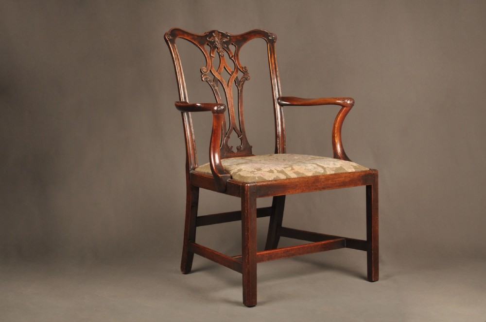 An 18th-century Chippendale mahogany armchair featuring a carved pierced splat back, swept armrests, an upholstered drop-in seat, and square legs joined by H-stretchers. View VII