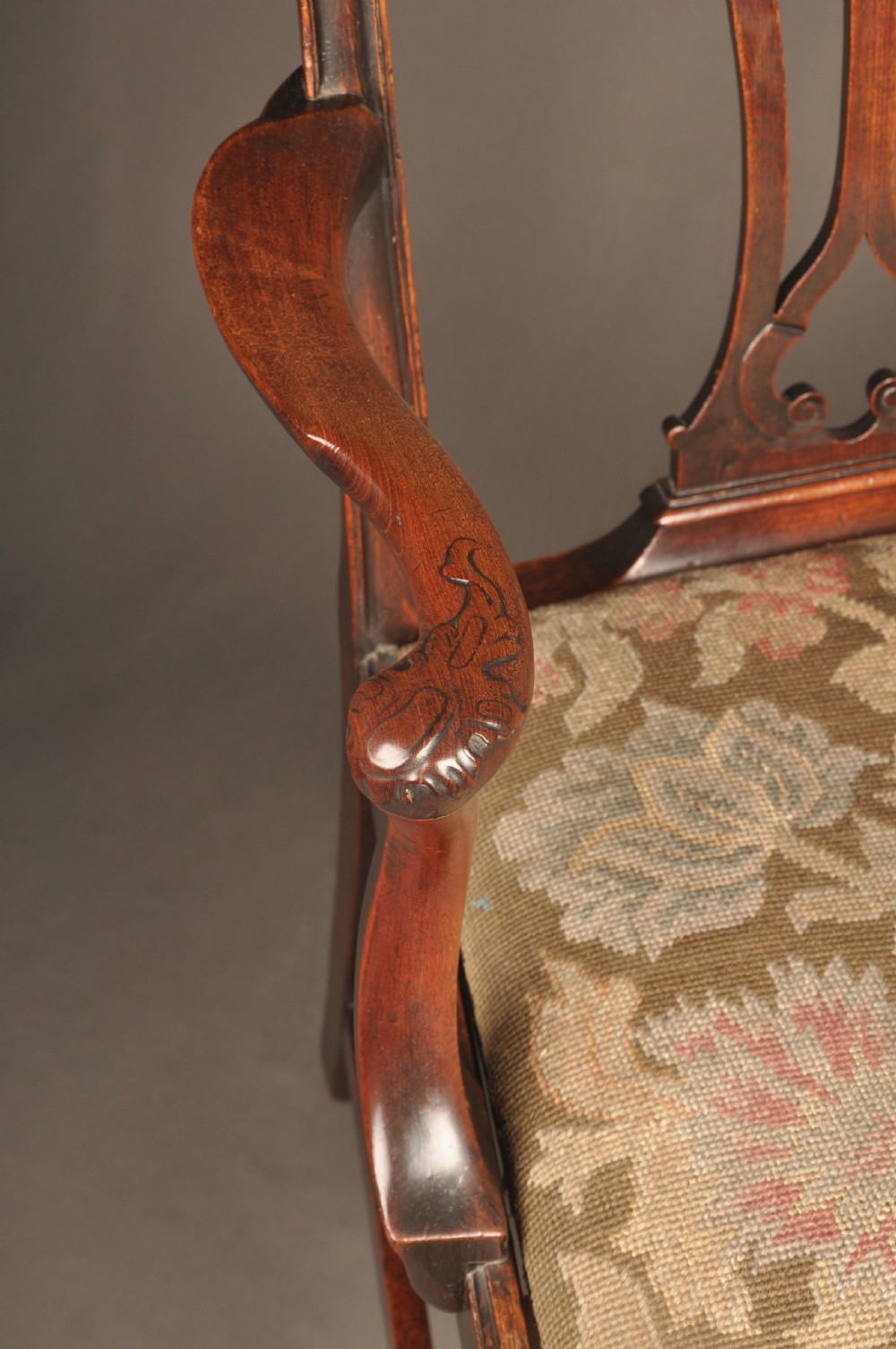 An 18th-century Chippendale mahogany armchair featuring a carved pierced splat back, swept armrests, an upholstered drop-in seat, and square legs joined by H-stretchers. View VIII