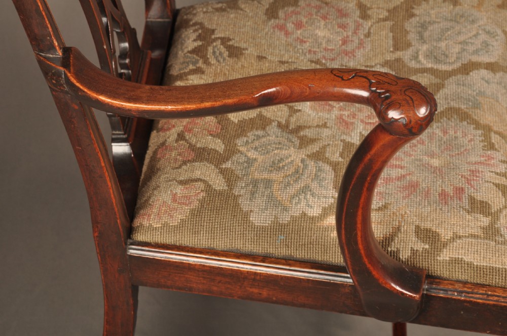 An 18th-century Chippendale mahogany armchair featuring a carved pierced splat back, swept armrests, an upholstered drop-in seat, and square legs joined by H-stretchers. View XI